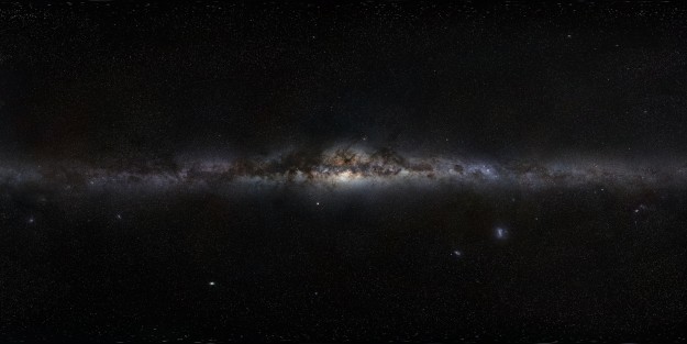 This magnificent 360-degree panoramic image, covering the entire southern and northern celestial sphere, reveals the cosmic landscape that surrounds our tiny blue planet. This gorgeous starscape serves as the first of three extremely high-resolution images featured in the GigaGalaxy Zoom project, launched by ESO within the framework of the International Year of Astronomy 2009 (IYA2009). The plane of our Milky Way Galaxy, which we see edge-on from our perspective on Earth, cuts a luminous swath across the image. The projection used in GigaGalaxy Zoom place the viewer in front of our Galaxy with the Galactic Plane running horizontally through the image — almost as if we were looking at the Milky Way from the outside. From this vantage point, the general components of our spiral galaxy come clearly into view, including its disc, marbled with both dark and glowing nebulae, which harbours bright, young stars, as well as the Galaxy’s central bulge and its satellite galaxies. As filming extended over several mon